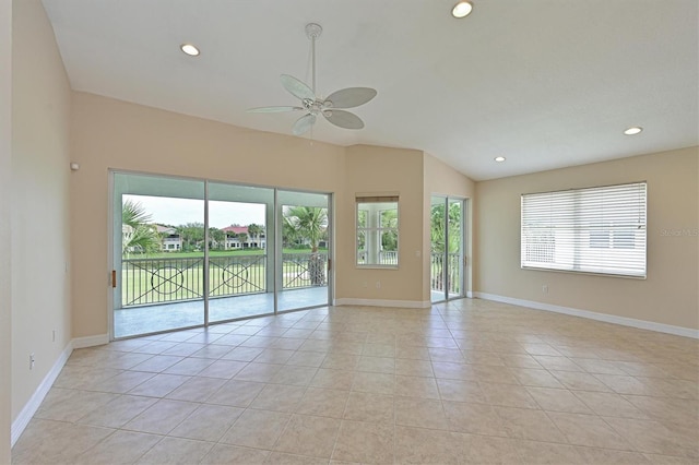 spare room featuring ceiling fan, light tile patterned floors, and vaulted ceiling