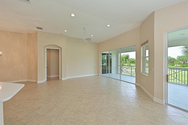 empty room with ceiling fan and light tile patterned floors