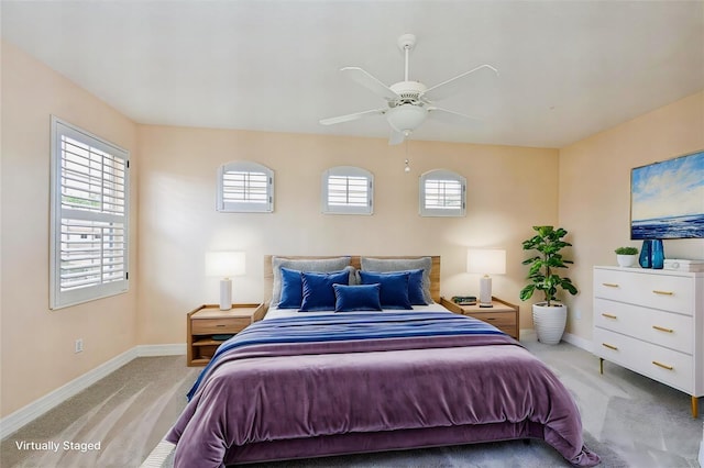 bedroom featuring light carpet and ceiling fan