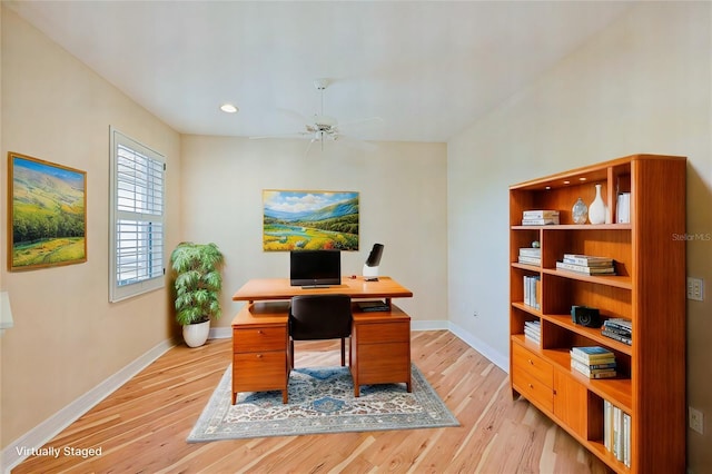 office space with light wood-type flooring and ceiling fan