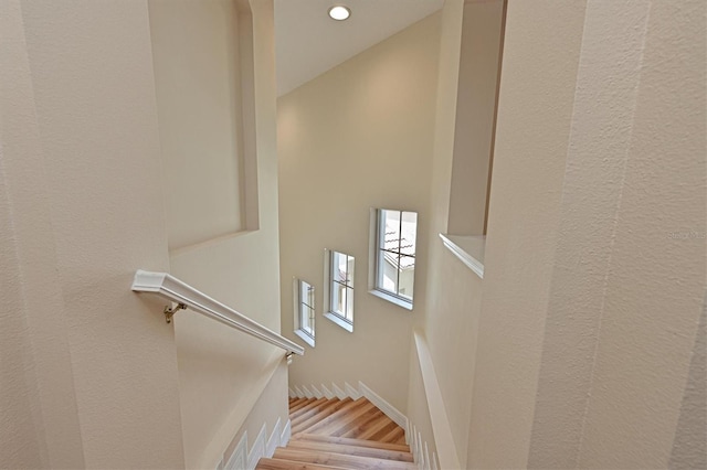 staircase with hardwood / wood-style flooring