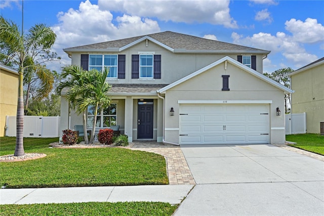 front of property featuring a front yard and a garage