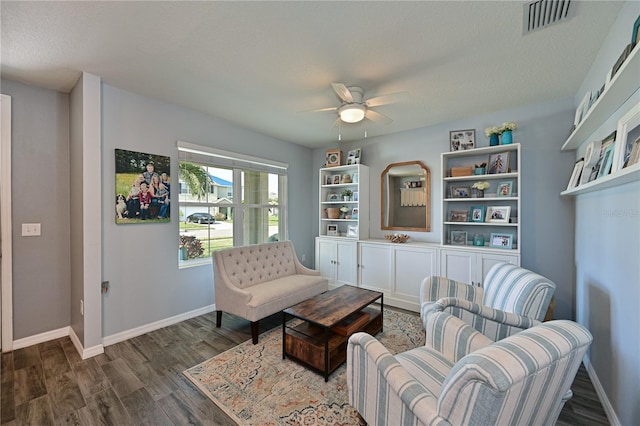 sitting room featuring a textured ceiling, dark hardwood / wood-style floors, and ceiling fan