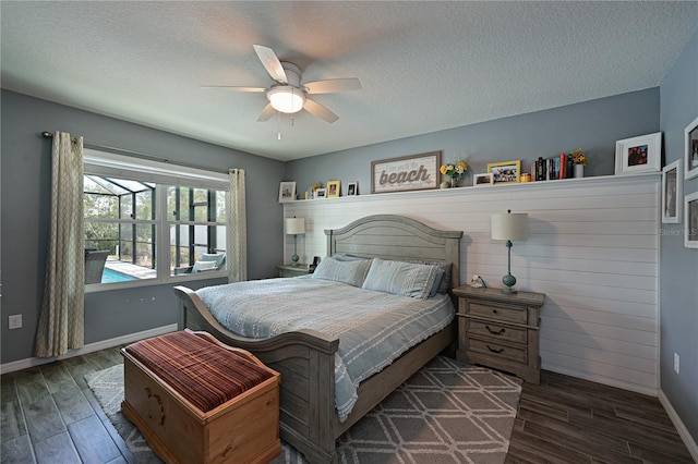 bedroom featuring ceiling fan, dark hardwood / wood-style flooring, and a textured ceiling