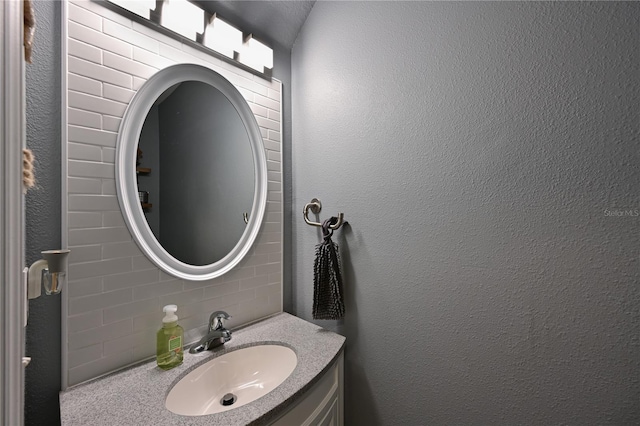 bathroom featuring decorative backsplash and vanity