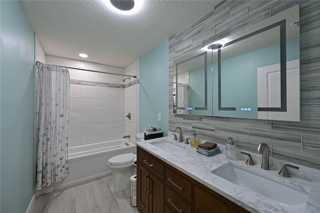 full bathroom with vanity, backsplash, toilet, a textured ceiling, and shower / tub combo with curtain