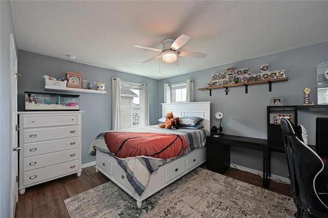 bedroom featuring ceiling fan, dark hardwood / wood-style flooring, and a textured ceiling