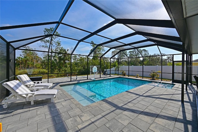 view of swimming pool with a lanai and a patio area