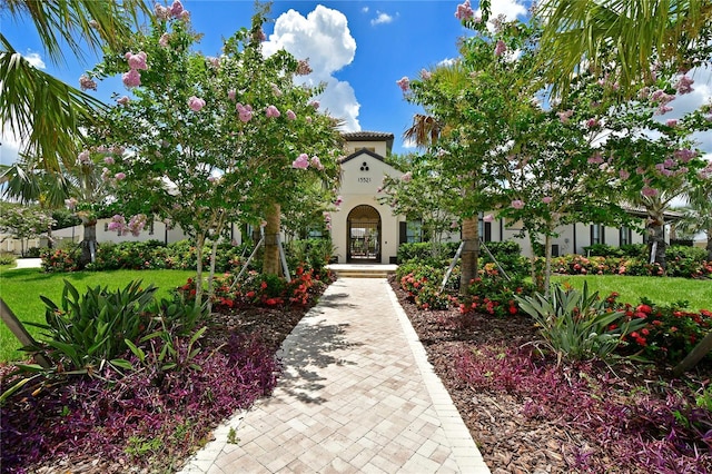 mediterranean / spanish-style house with a front yard