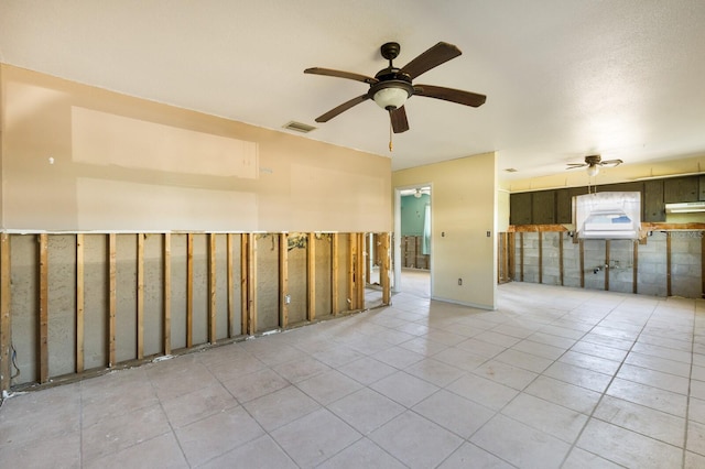 empty room featuring ceiling fan and light tile patterned floors