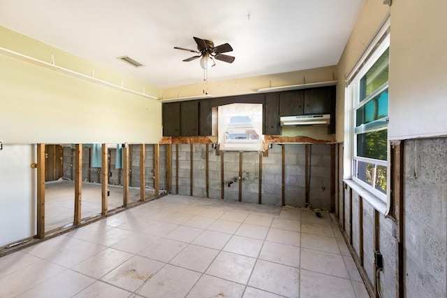 interior space with ceiling fan and light tile patterned floors