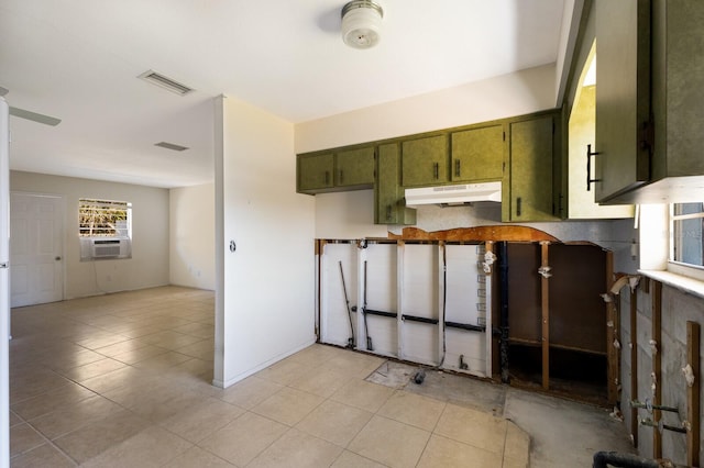 kitchen featuring cooling unit, light tile patterned flooring, and green cabinetry