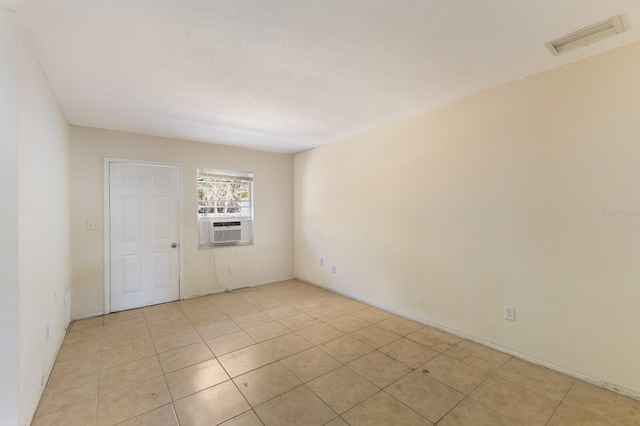 empty room with cooling unit and a textured ceiling