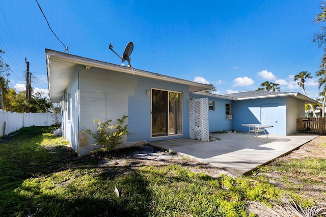 back of property featuring a patio area and a yard