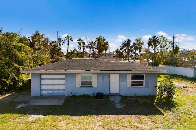 view of front of house with a garage and a front lawn