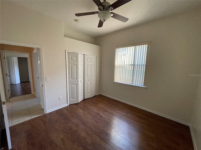 unfurnished bedroom with a closet, ceiling fan, and hardwood / wood-style flooring