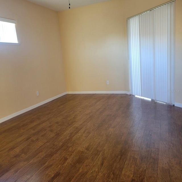 empty room featuring dark hardwood / wood-style flooring