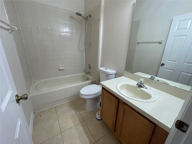 full bathroom featuring toilet, vanity, tile patterned floors, and tiled shower / bath combo