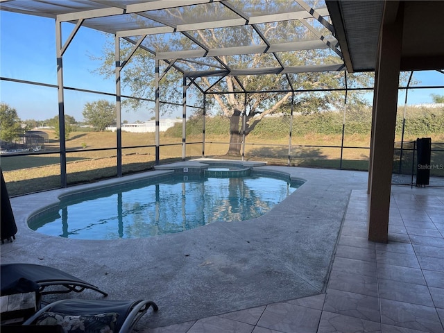 view of swimming pool with an in ground hot tub, glass enclosure, and a patio