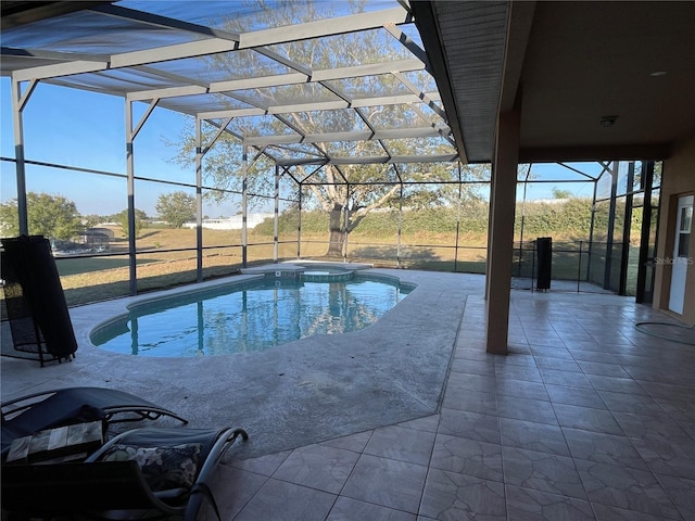 view of swimming pool featuring a lanai and a patio