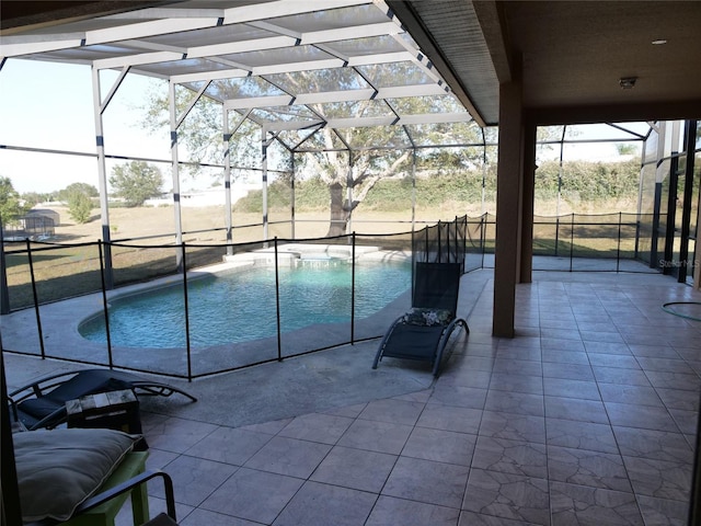 view of pool featuring a patio and glass enclosure