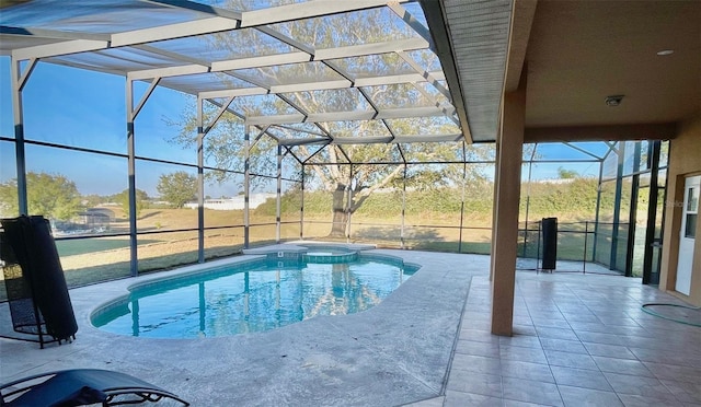 view of pool featuring glass enclosure, a patio area, and a pool with connected hot tub