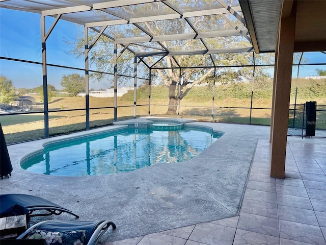 view of swimming pool with glass enclosure, a pool with connected hot tub, and a patio area