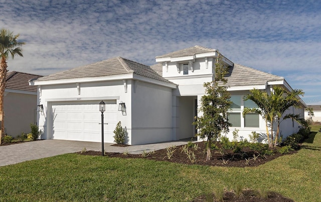 view of front of home featuring a front yard and a garage