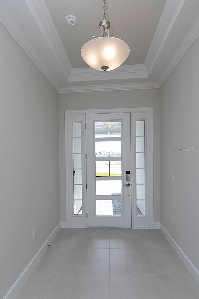 doorway to outside featuring light tile patterned flooring, a raised ceiling, and crown molding