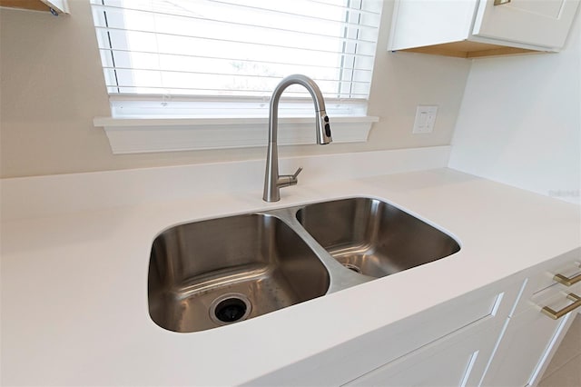 interior details with white cabinets and sink