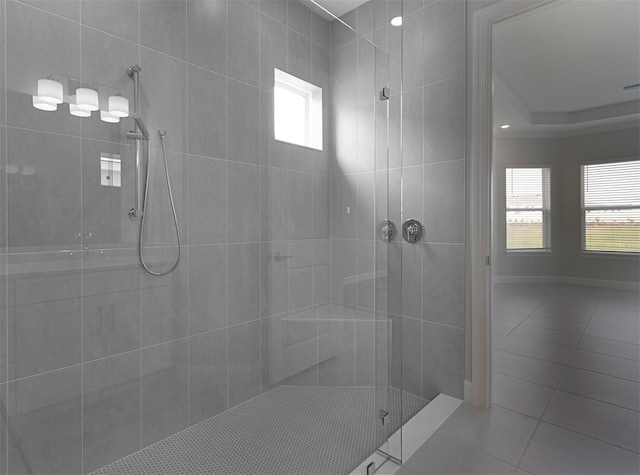 bathroom featuring tile patterned flooring and tiled shower