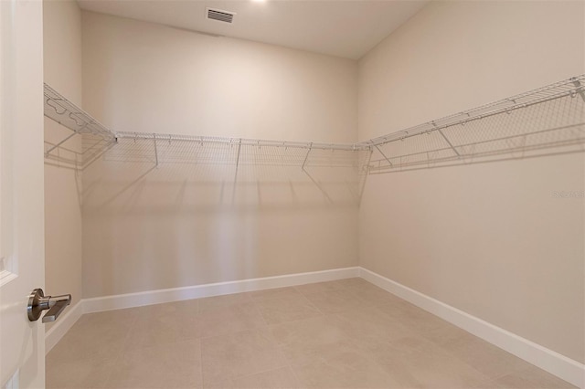 walk in closet with tile patterned flooring