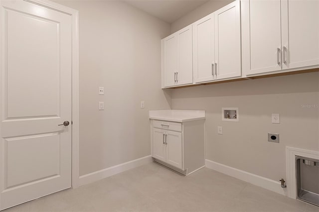 washroom featuring hookup for an electric dryer, washer hookup, hookup for a gas dryer, and cabinets