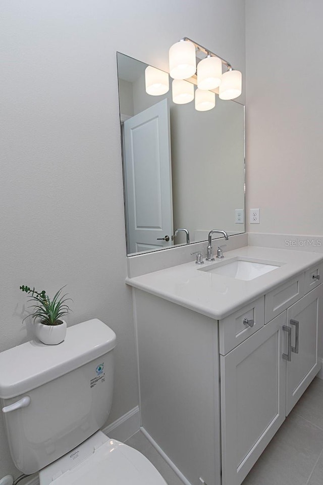 bathroom with tile patterned floors, vanity, and toilet