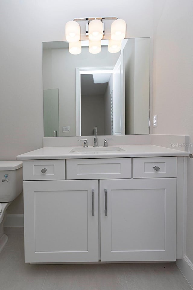 bathroom with tile patterned floors, vanity, and toilet