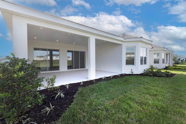 view of side of home featuring a lawn