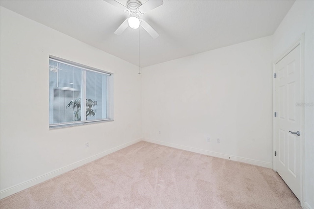 unfurnished room featuring light carpet and ceiling fan