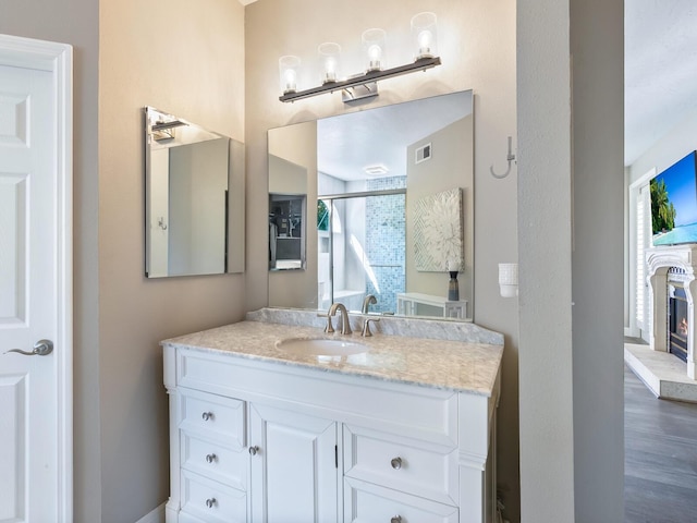 bathroom with vanity and a shower with shower door