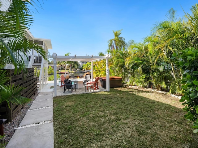 view of yard featuring a patio, a pergola, a hot tub, and a fire pit