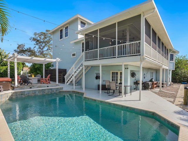 back of property featuring a sunroom and a patio area