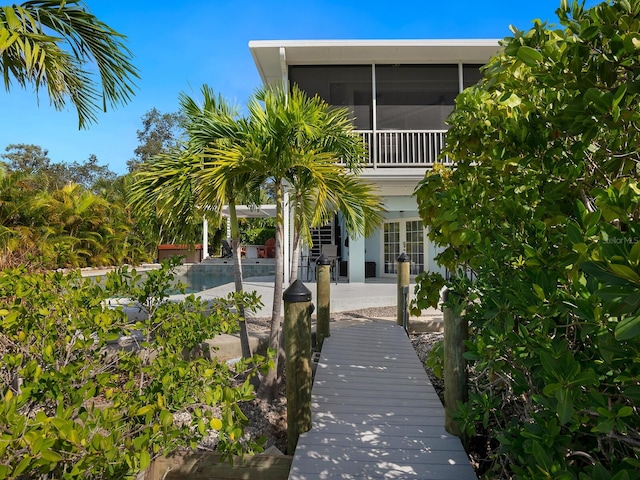 back of house featuring a sunroom and a patio