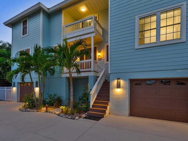 view of front of property featuring a balcony and a garage