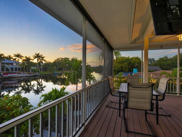 sunroom / solarium with a water view