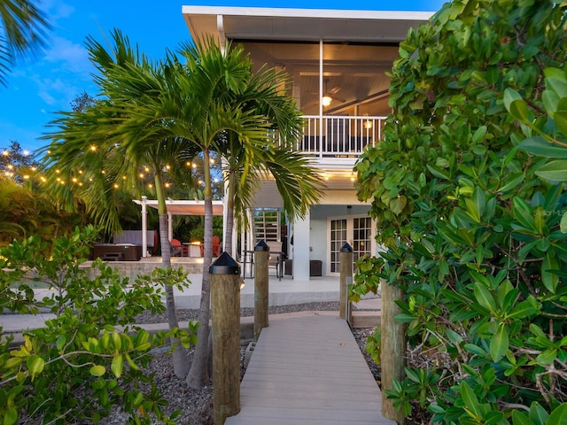 rear view of house featuring a patio area and a sunroom