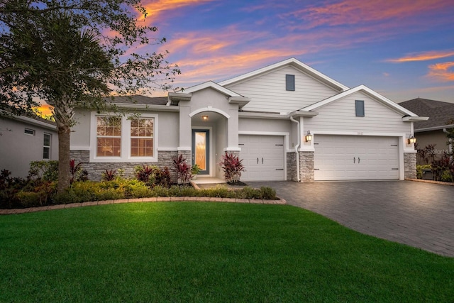 view of front facade with a garage and a yard