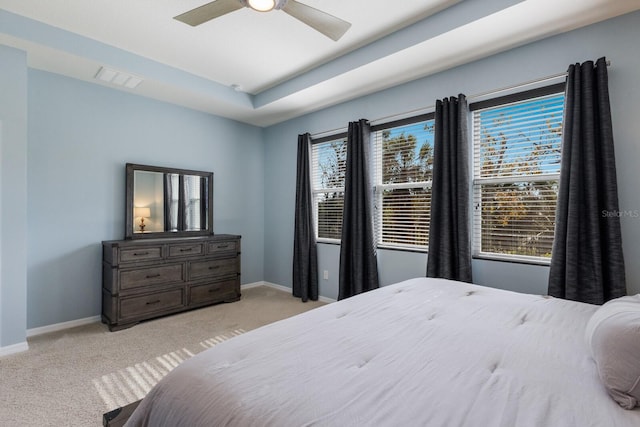 carpeted bedroom featuring ceiling fan and multiple windows