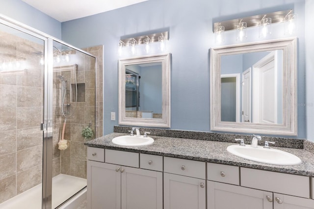 bathroom with walk in shower and vanity