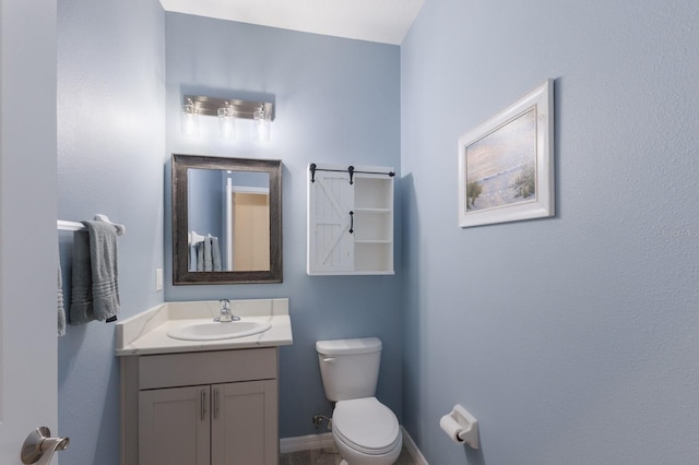 bathroom featuring toilet and vanity