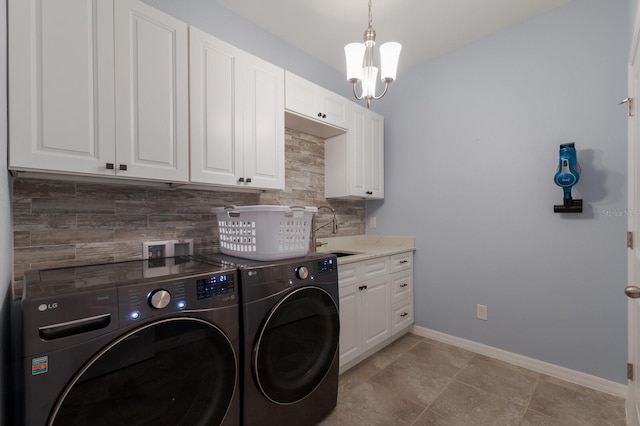 laundry area featuring sink, independent washer and dryer, a chandelier, and cabinets