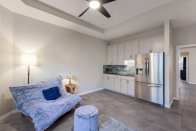 interior space featuring ceiling fan and sink